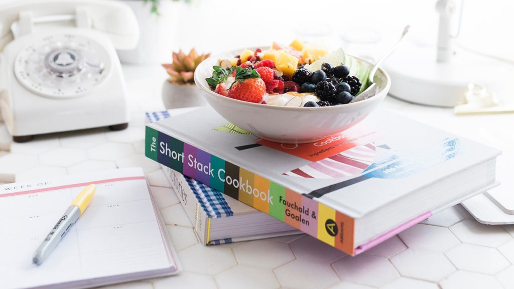 decorating with cookbooks, a stack of cookbooks on a table