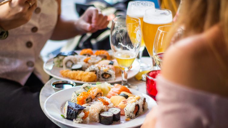 A table full of sushi and beer