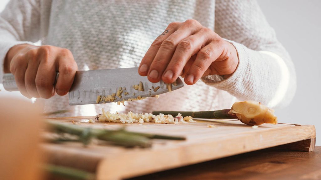 Chopping garlic on a cutting board