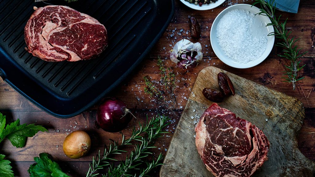 salt and steaks on a table