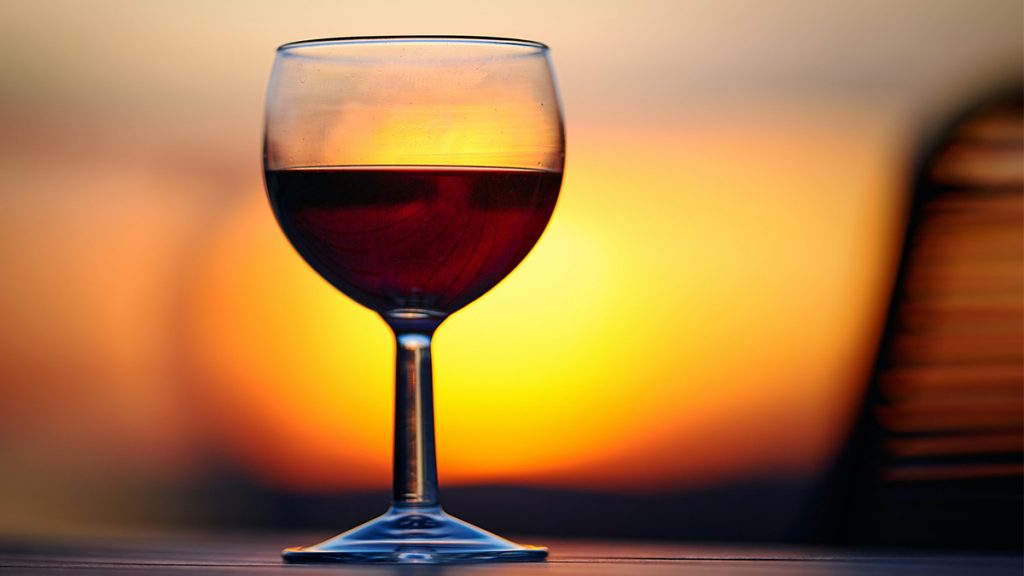 A glass of wine at sunset