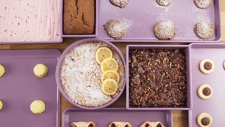 Colored cookware spread out on a table