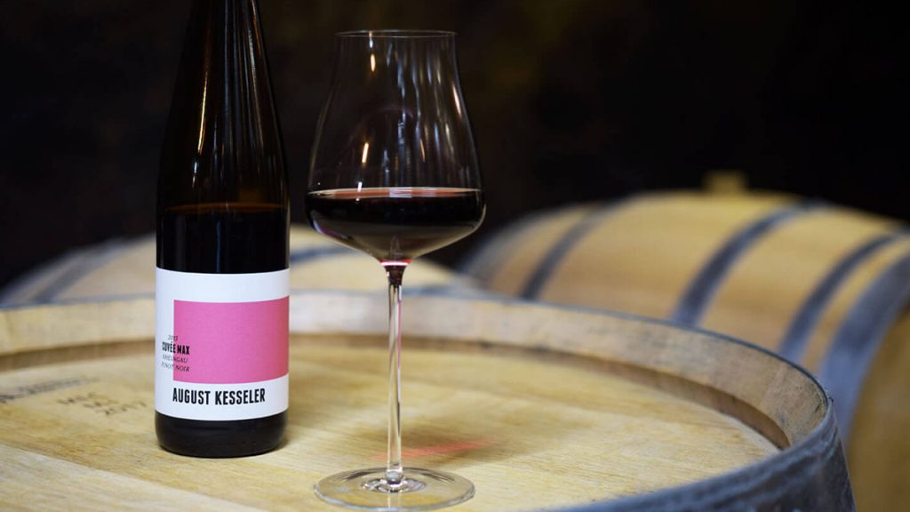 A glass and bottle of Pinot Noir on the table