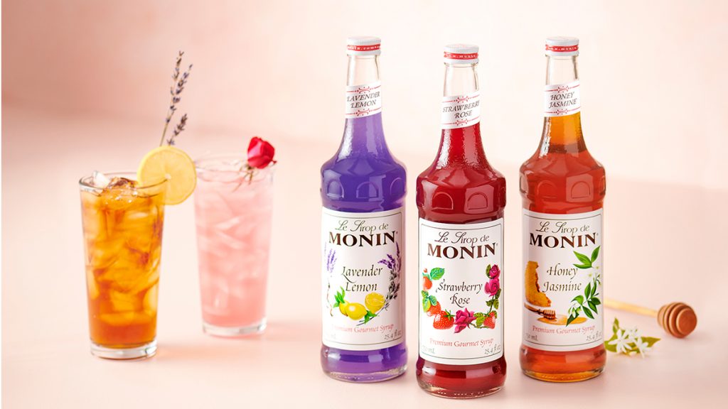 Monin syrups on a table with cocktails
