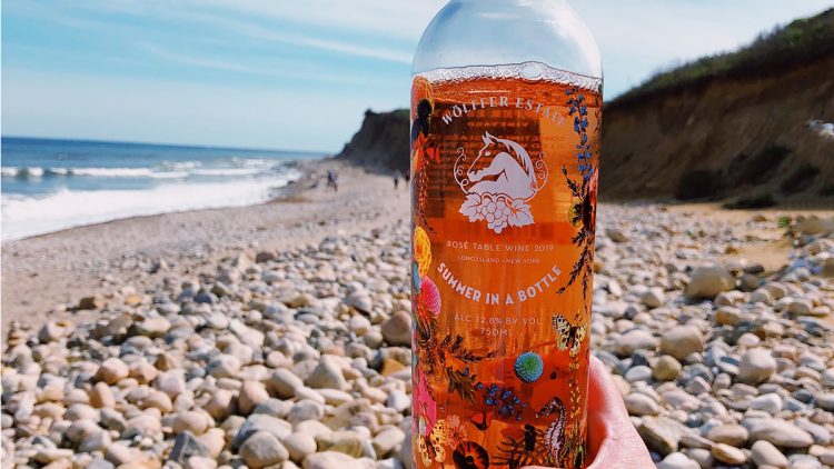 A bottle of Summer In A Bottle on the beach